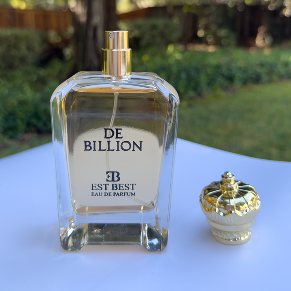 DE BILLION perfume bottle with golden cap opened, displayed on white surface, EST BEST Eau de Parfum.
