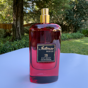 INTENSE ROUGE Eau de Parfum bottle with open cap – luxurious red bottle and gold sprayer