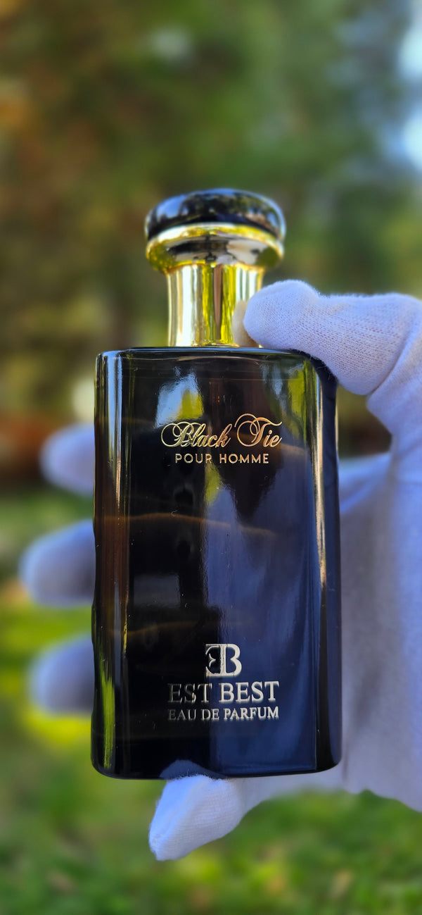 BLACK TIE perfume box with EST BEST branding outdoors