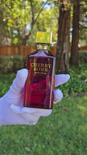 Unboxing video of Cherry Bomb perfume showing red-and-gold packaging and elegant 100 ml bottle design.
